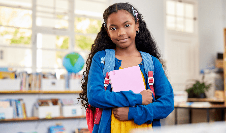 Student holding book in classroom