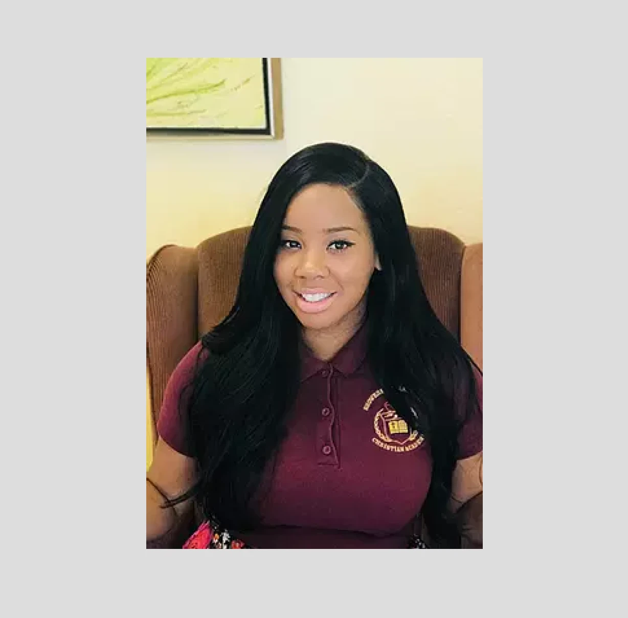 Woman smiling in maroon shirt
